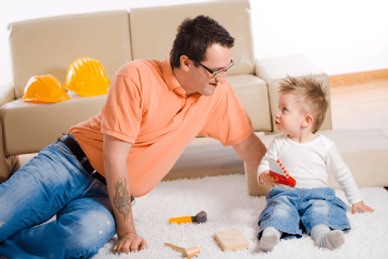 Father and Son Playing Together at Home