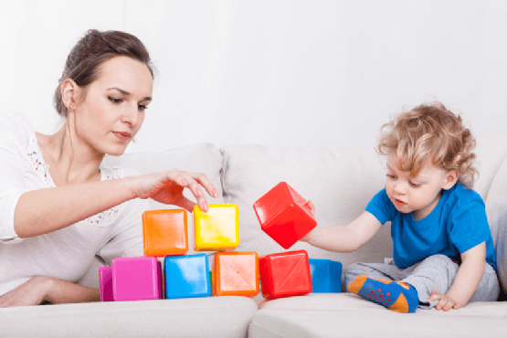 Mother and son playing blocks